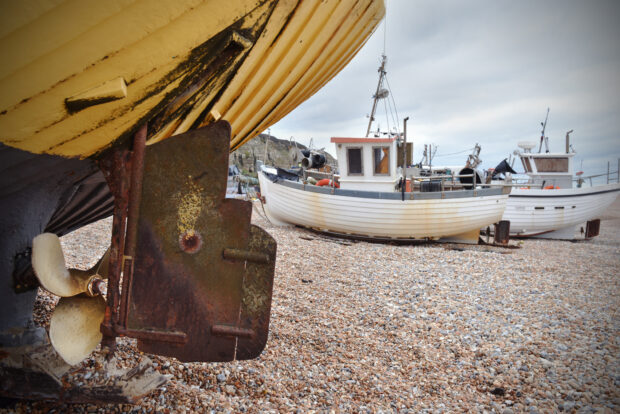 Boats rest on the beach in Hastings.